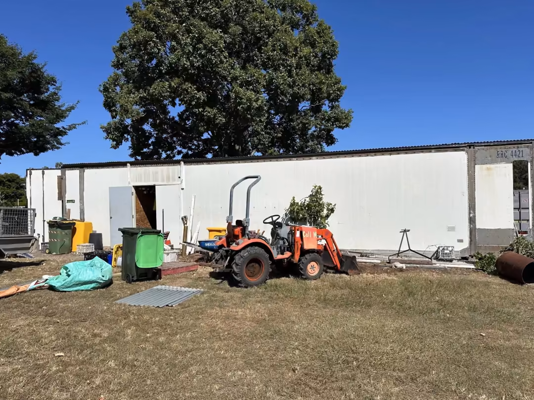Building site with transportable buildings and a small excavator