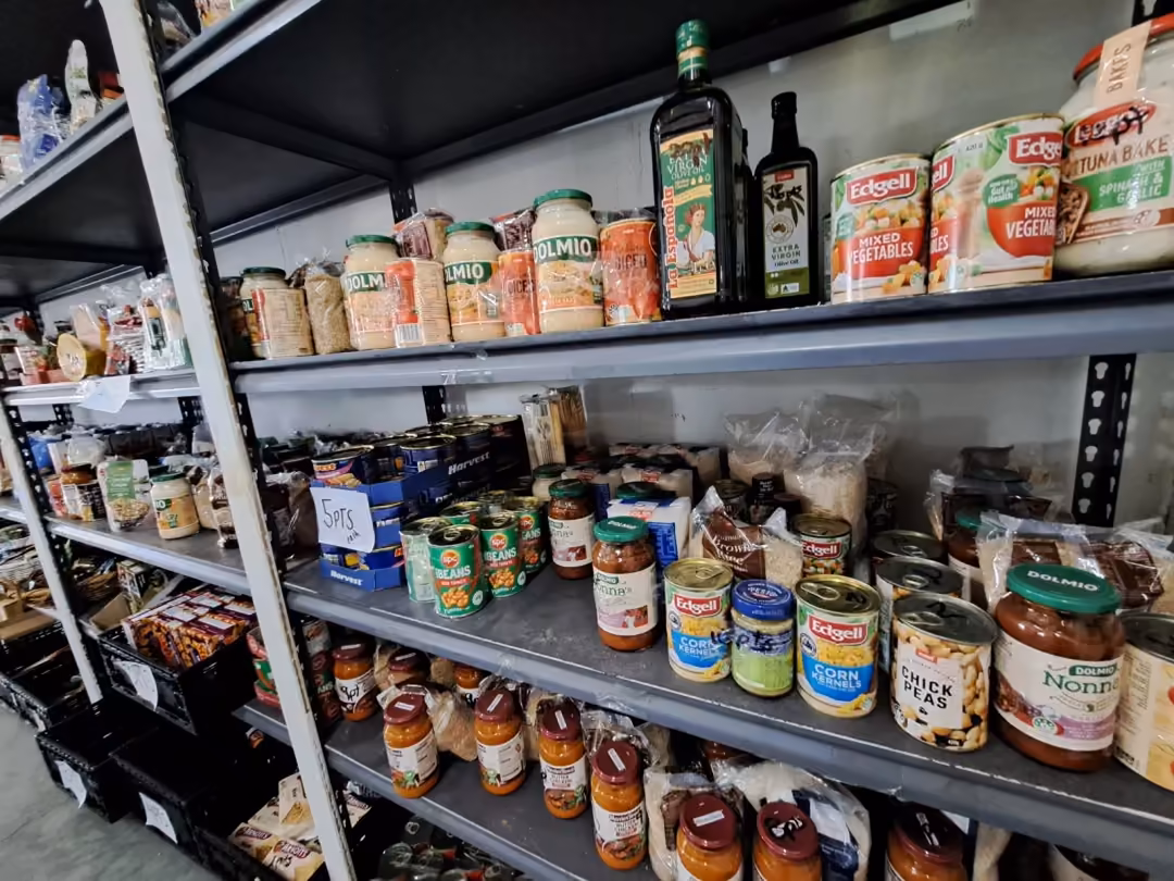 Shelves of cooking oils, sauces and tinned goods