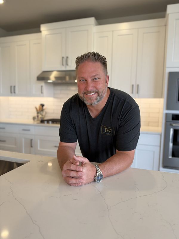 Brandon Muzatko smiling in a kitchen