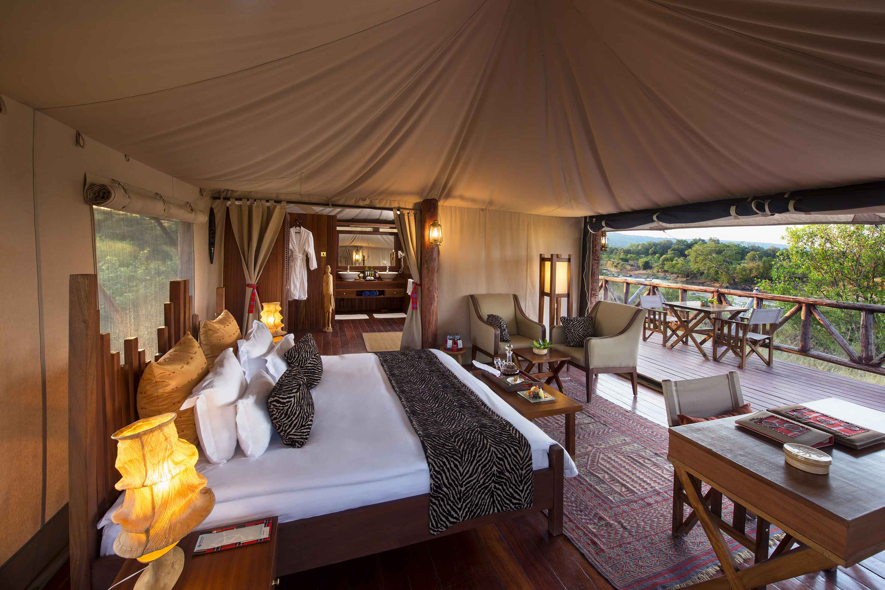 A luxurious tented suite interior overlooking the Mara River