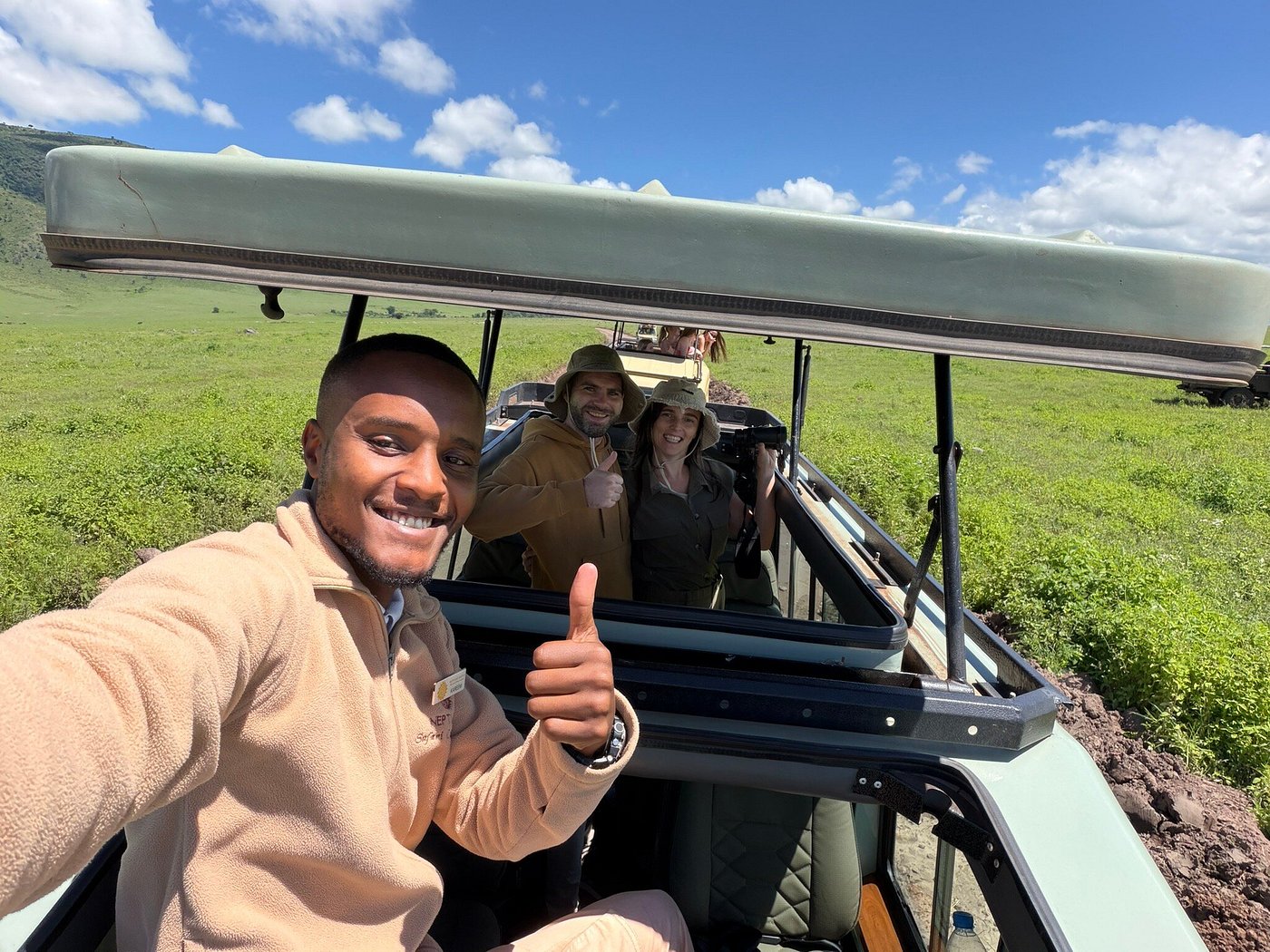 A Neptune guide tracking wildlife from an open vehicle