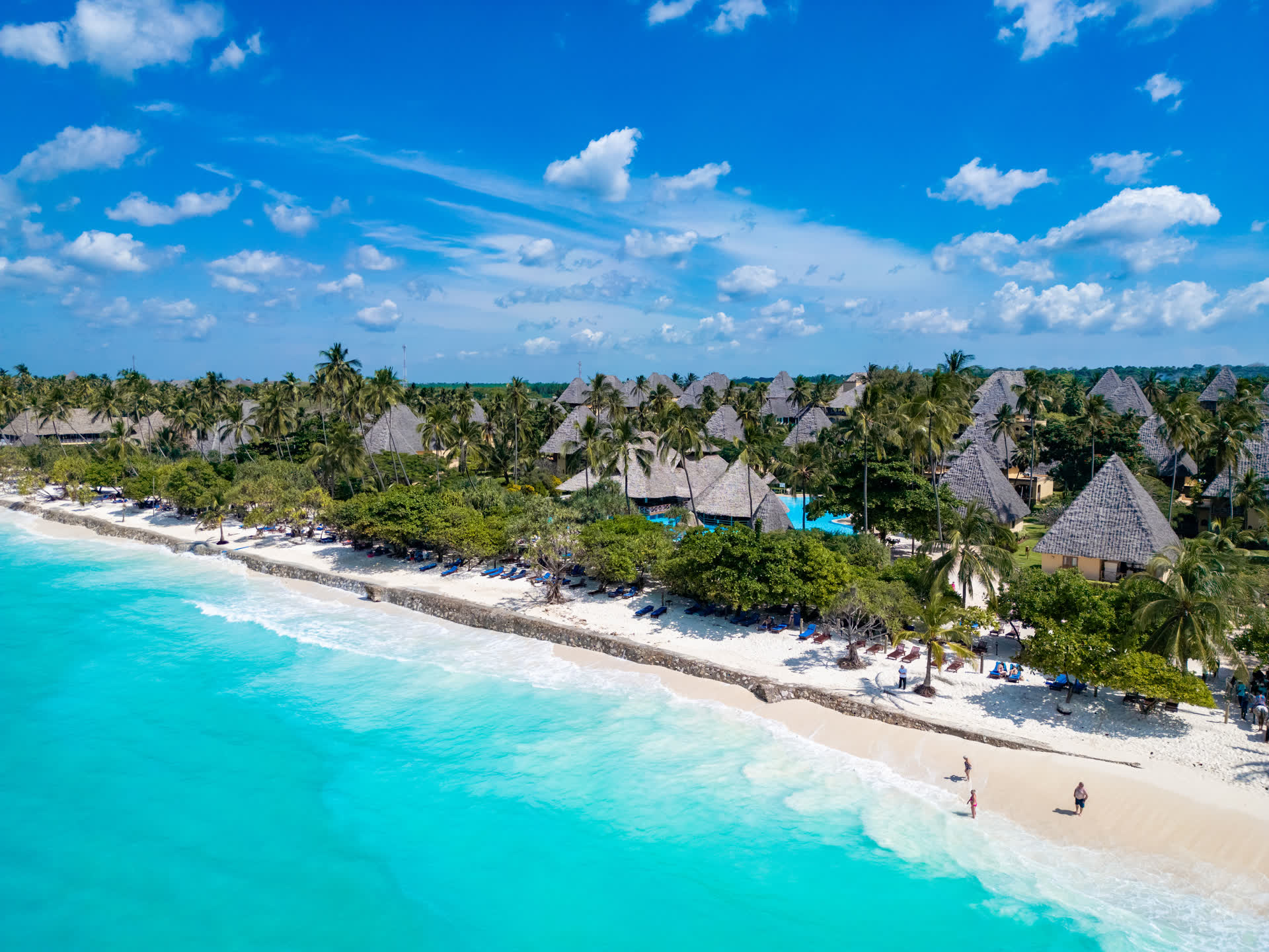 Aerial view of Neptune Pwani's white-sand beach and turquoise shallows on the Zanzibar coast