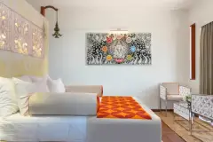 Deluxe Room at Ayurvie Weligama in Sri Lanka featuring contemporary Ayurvedic-inspired décor, chakra artwork, and a serene wellness-focused interior.