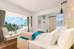 Deluxe Room at Ayurvie Weligama in Sri Lanka featuring an ocean-view balcony, bright coastal design, and contemporary wellness-inspired décor.