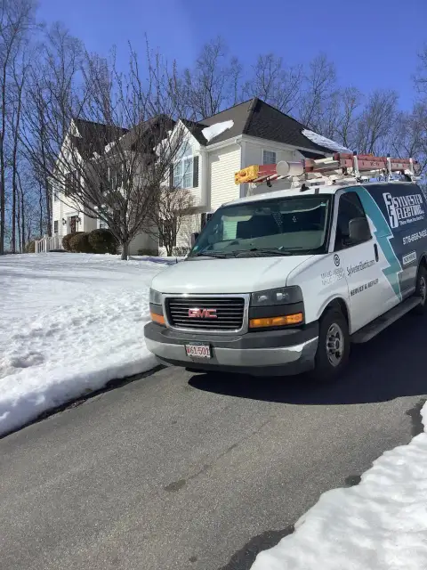 Sylvester Electric branded service van parked outside a home