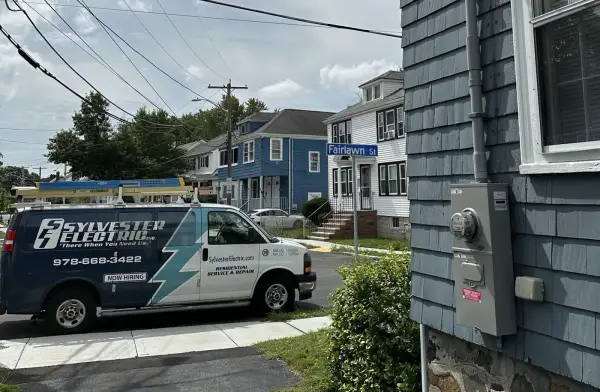 Sylvester Electric service van beside a home with an exterior electric meter