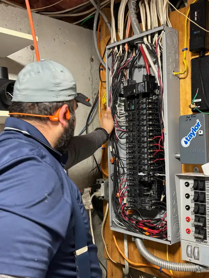 Sylvester Electric technician working at an electrical panel