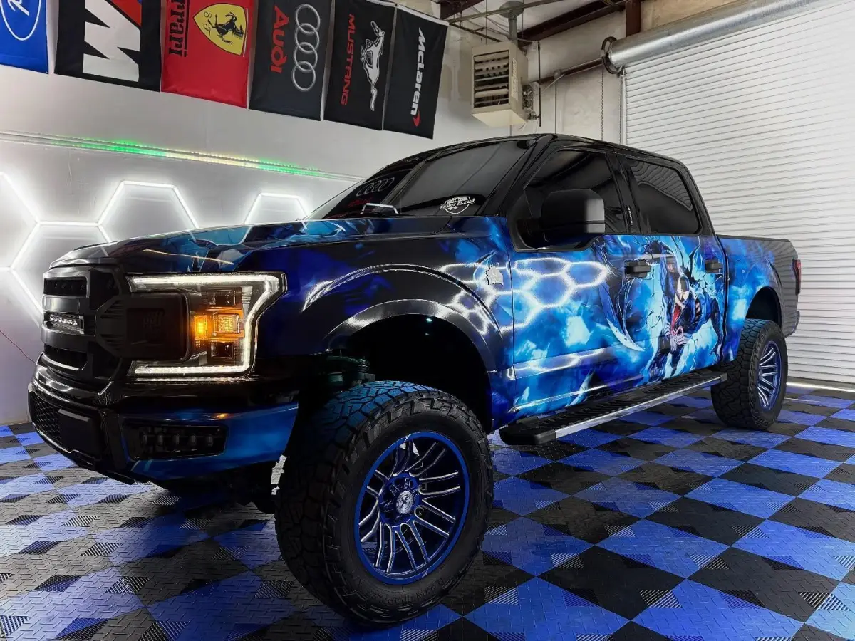 Venom Tint’s blue-wrapped shop truck inside the Acworth shop