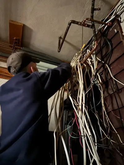 Original Sylvester Electric technician photo showing electrical wiring work