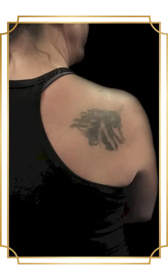 Faded tattoo on the shoulder blade before a tattoo cover-up