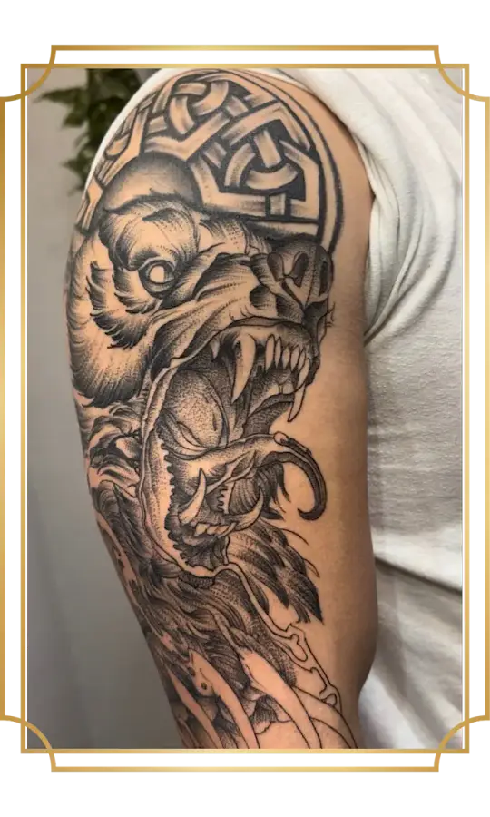 Blackwork snarling dog and skull tattoo on the upper arm
