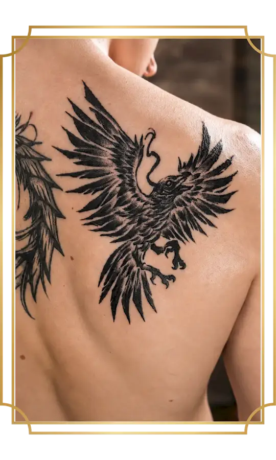 Blackwork raven tattoo with outstretched wings on the upper back