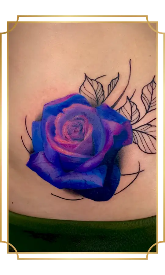 Blue and purple rose tattoo with black botanical linework on the lower back
