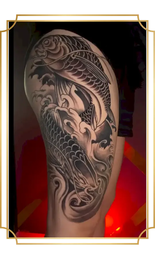 Black and gray Japanese koi fish tattoo with flowing waves on the leg