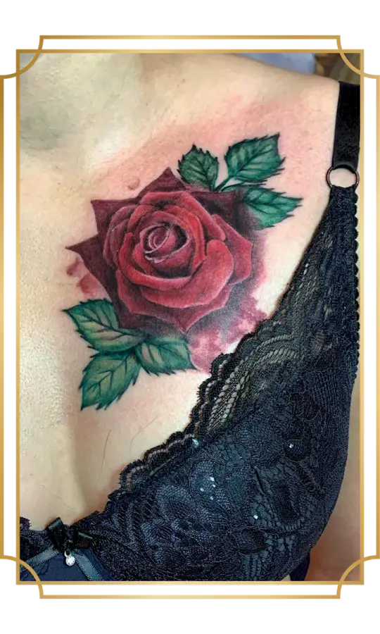 Realistic red rose tattoo with green leaves on the upper chest
