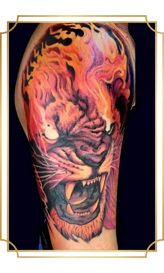 Full-color roaring tiger upper-arm tattoo surrounded by flowing orange, red and purple flames by San Marcos tattoo artist Alek the Saint