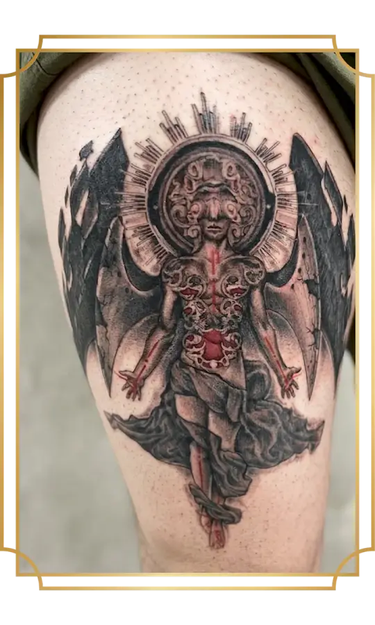 black and gray stone angel tattoo with red elements on the thigh