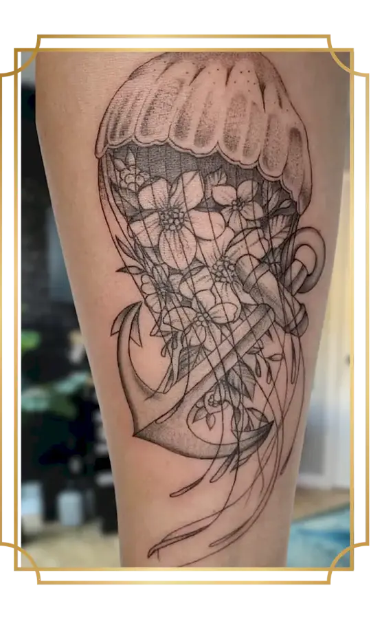 Illustrative fine-line jellyfish and anchor tattoo with flowers inside the bell, flowing tentacles and delicate dot shading, created in San Marcos