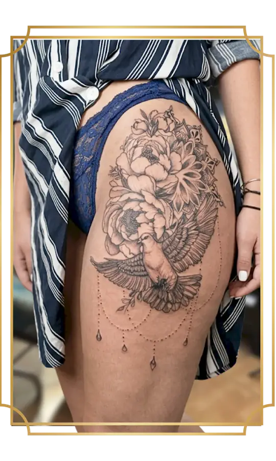 Ornamental fine-line thigh tattoo by San Marcos artist Alek the Saint, featuring a spread-wing owl, peonies, a mandala and hanging jewel details