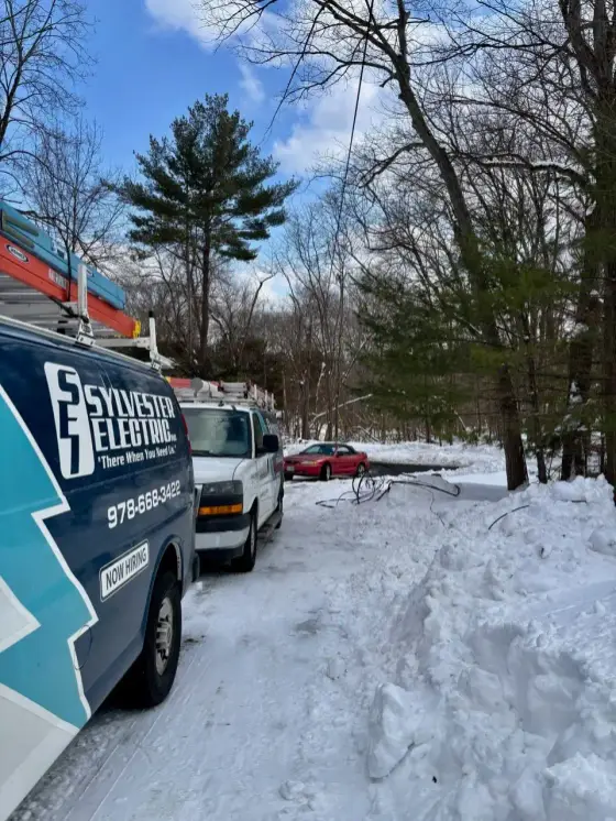 Sylvester Electric service vans parked in winter
