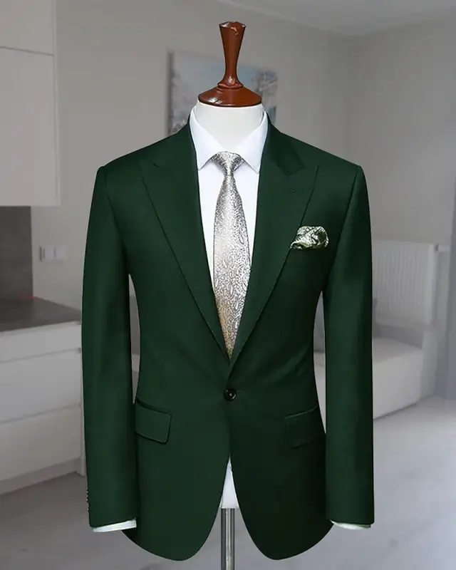 A green suit jacket with a white dress shirt and pocket square with a grey tie