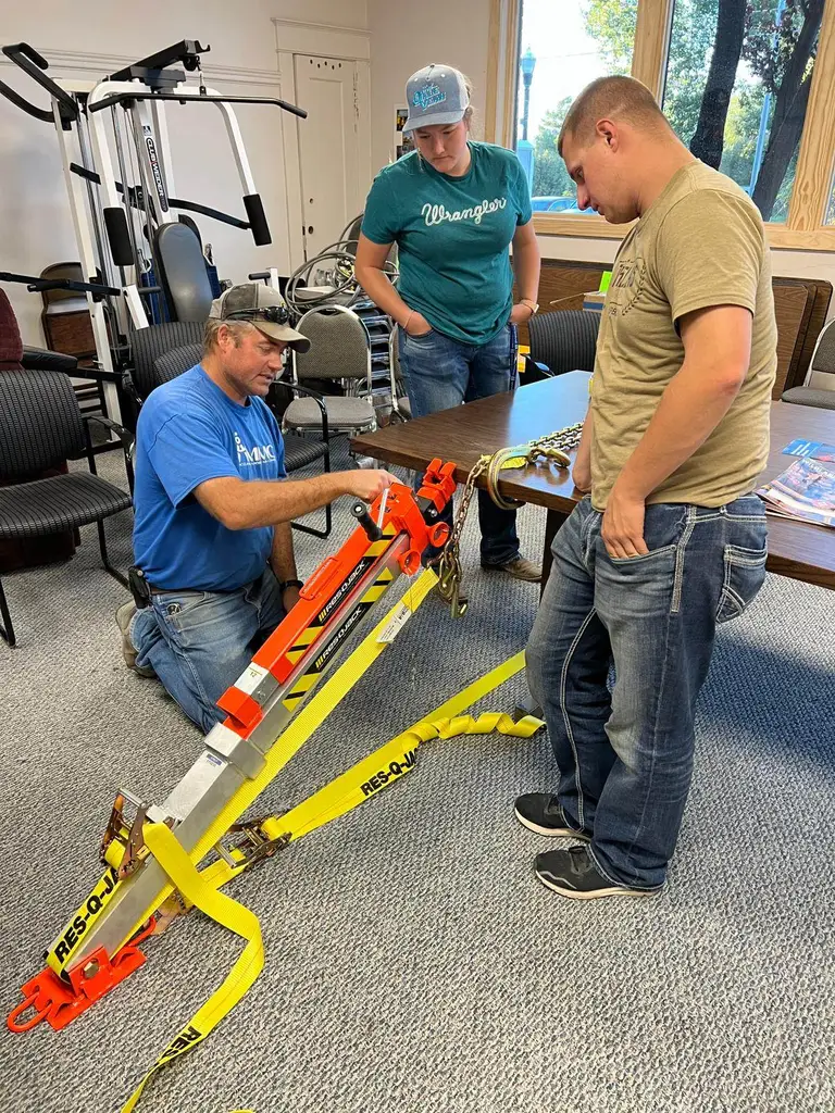Volunteers setting up vehicle stabilization struts during rescue training