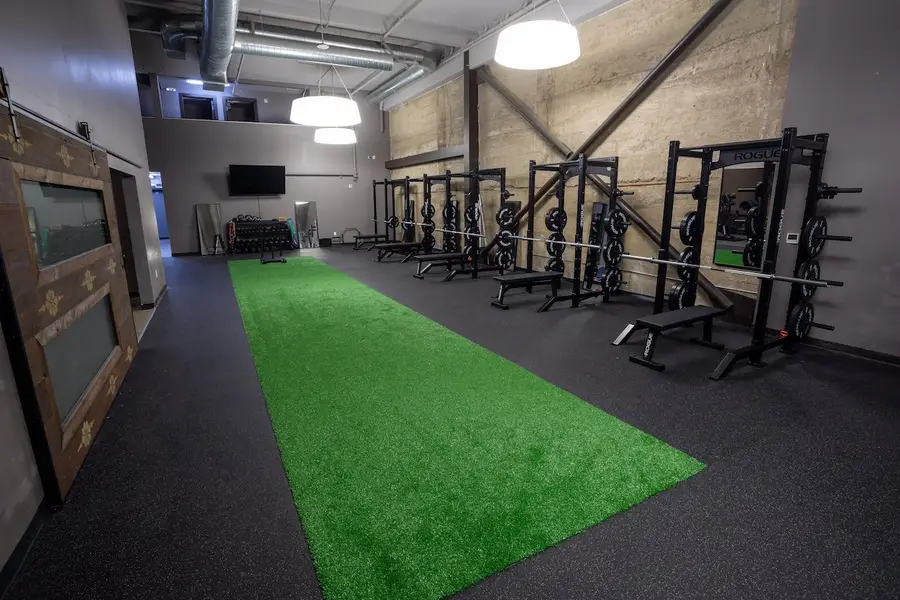 The Pro+Kinetix Oakland training floor: turf, Rogue racks and open space