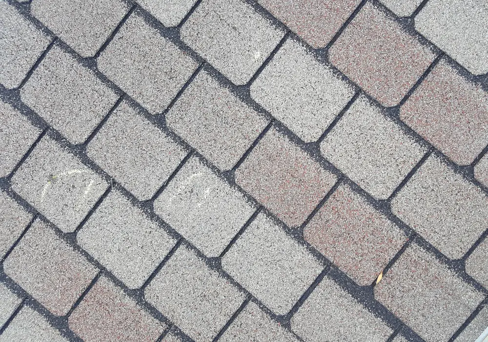 Close-up of asphalt shingles during a Repair King hail inspection