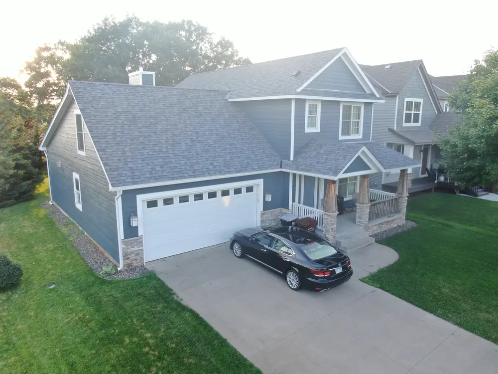 Finished Repair King siding and roofing job with the driveway in front