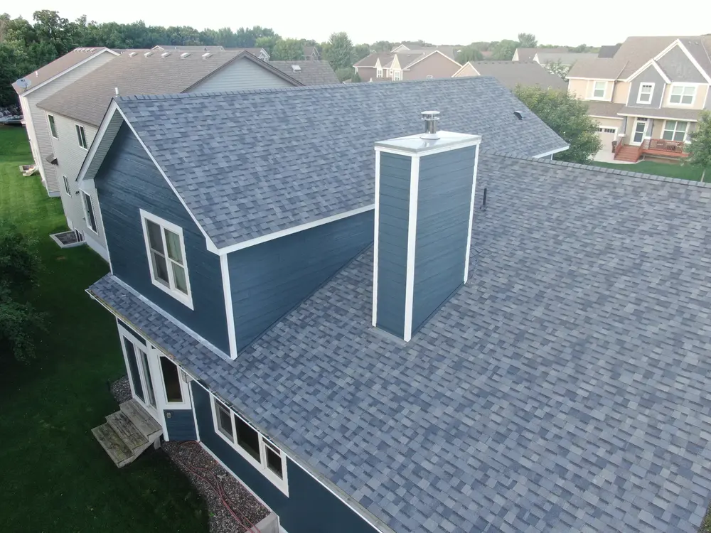 Chimney chase, siding and shingles on a Repair King siding job, drone photo
