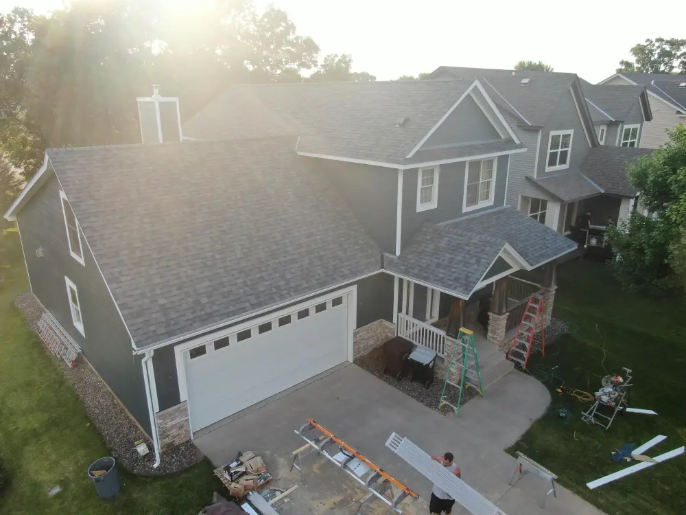 New blue LP SmartSide siding and shingle roof on a Minnesota home, drone photo from a Repair King job
