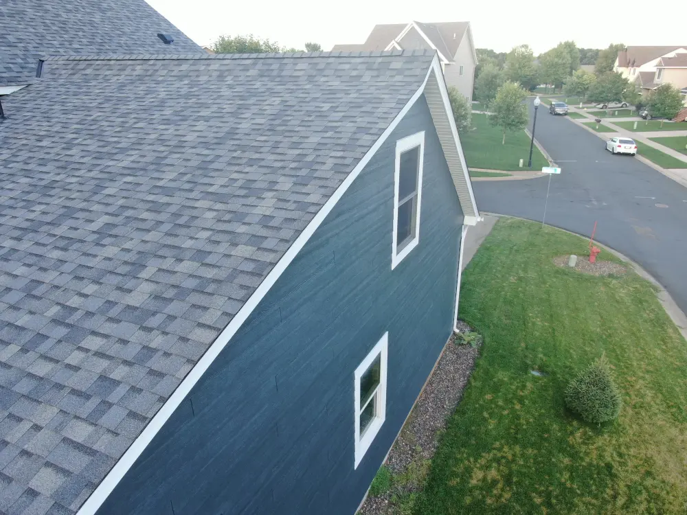 Side wall of new LP SmartSide siding under a new shingle roof