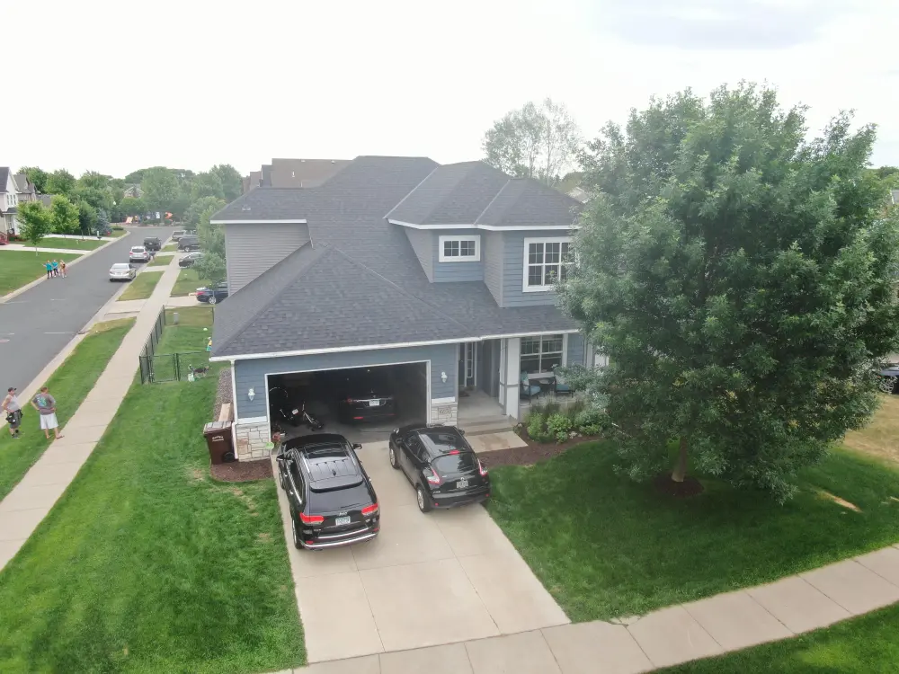 Aerial view of a finished home on a tree-lined Minnesota street