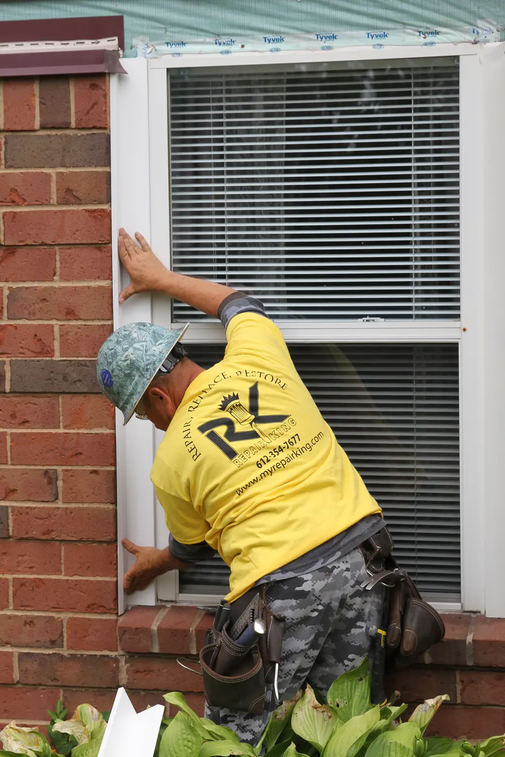 Repair King crew member working at a window on a senior living building in Oakdale, MN