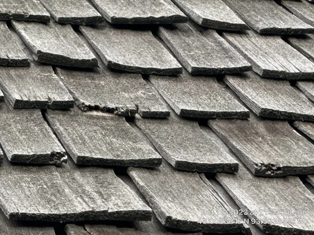 Aging cedar shakes photographed during a Repair King roof inspection