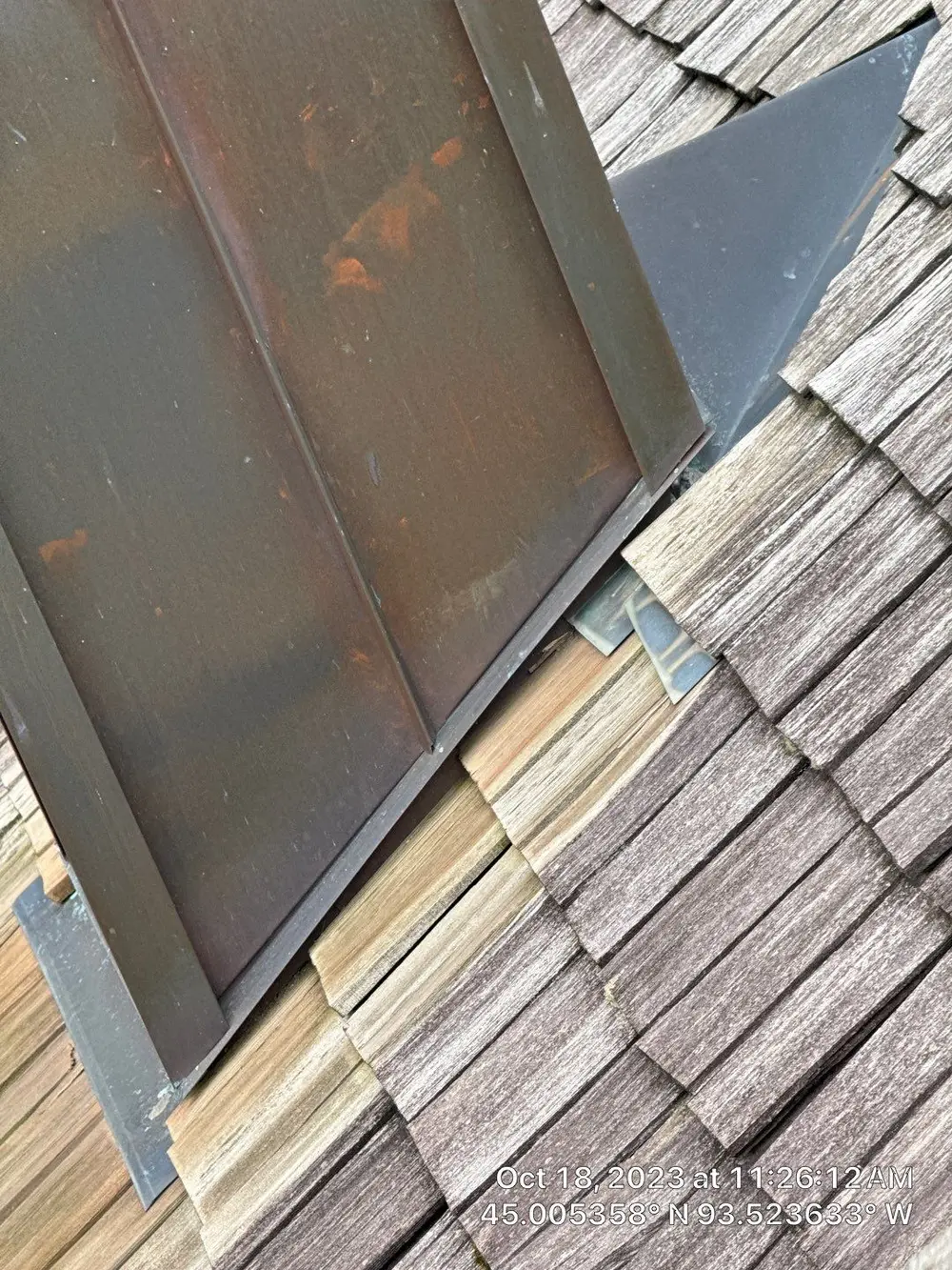 Metal flashing where a roof meets a wall on a cedar shake roof