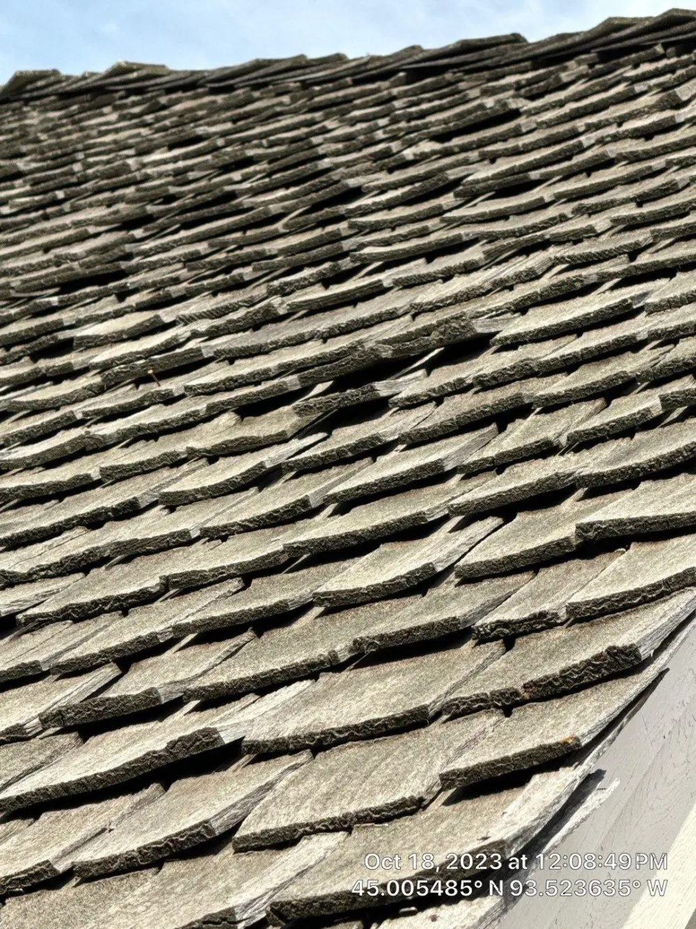 Worn cedar shake slope seen from the roof edge