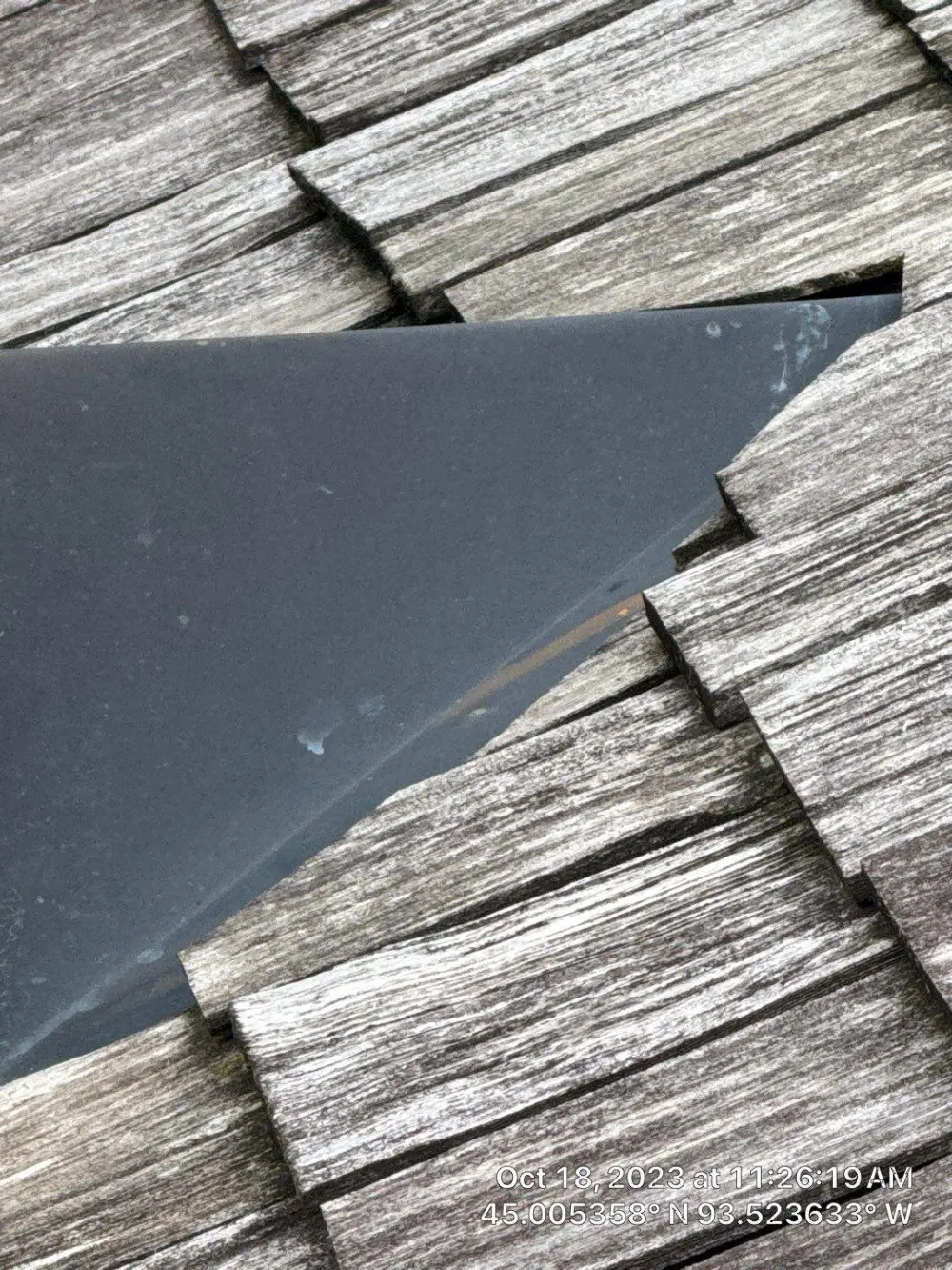 Metal flashing against weathered cedar shakes