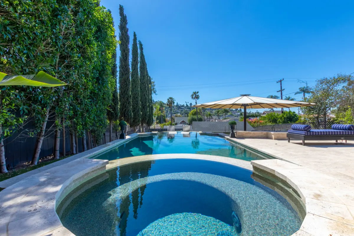 Round spa overlooking the pool and umbrellas