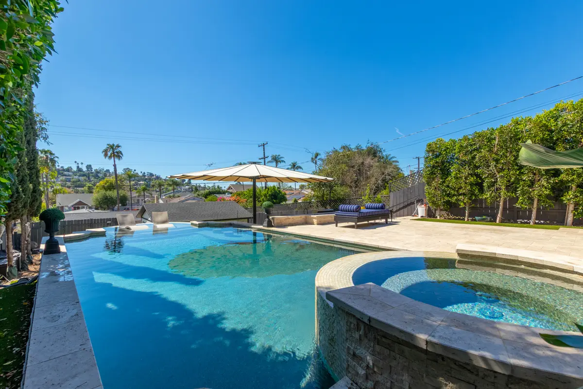 Stone spa next to a sparkling pool