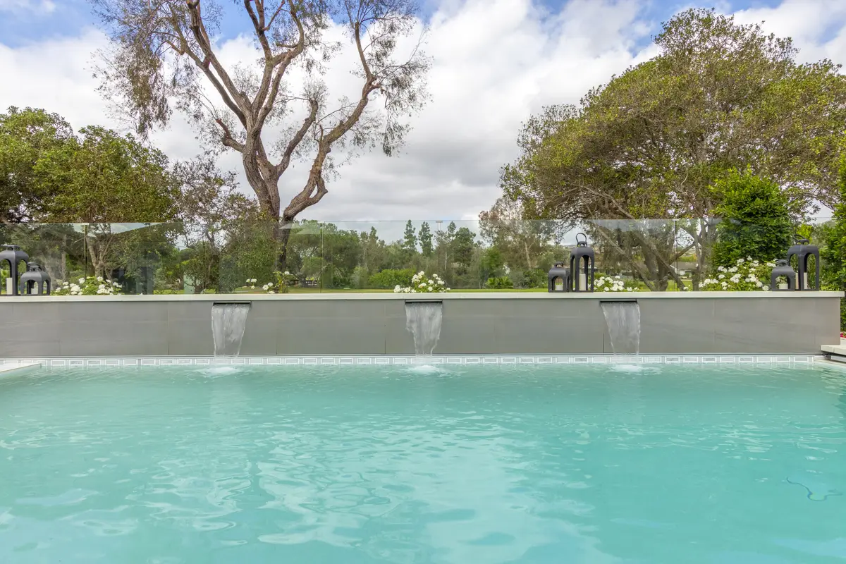 Three spillways pouring into the pool