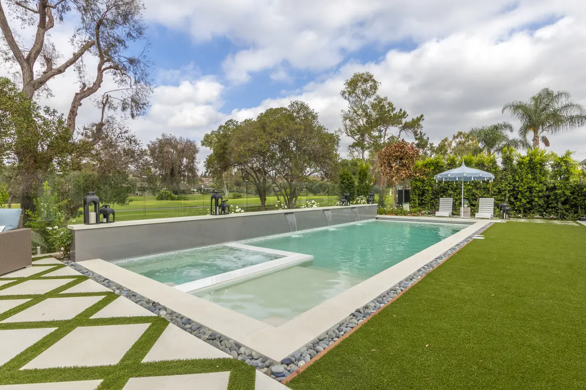 Pool with sun shelf, turf and pavers