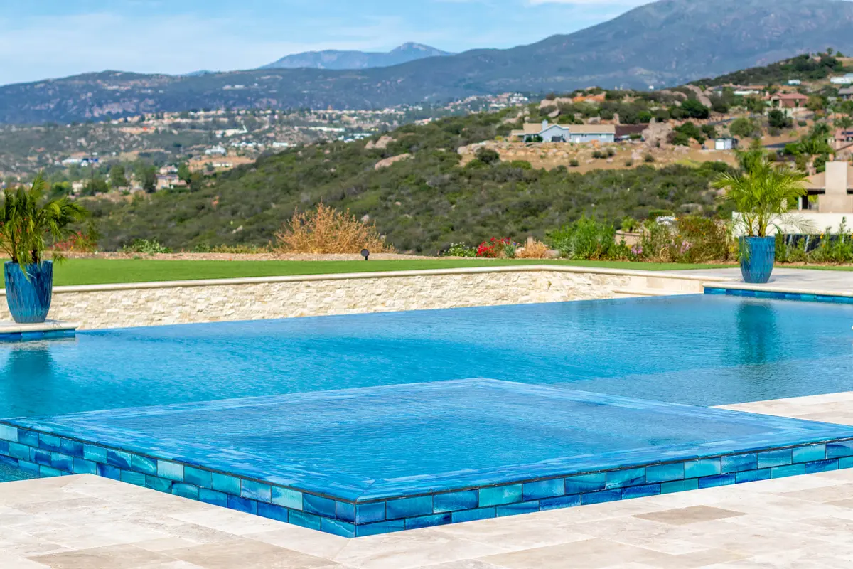 Built-in stainless outdoor kitchen with stone countertops