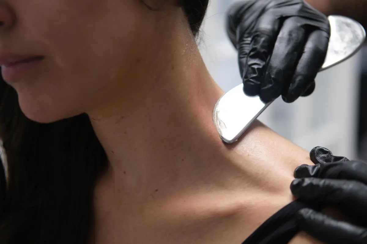 Clinician performing hands-on manual therapy on a patient's shoulder