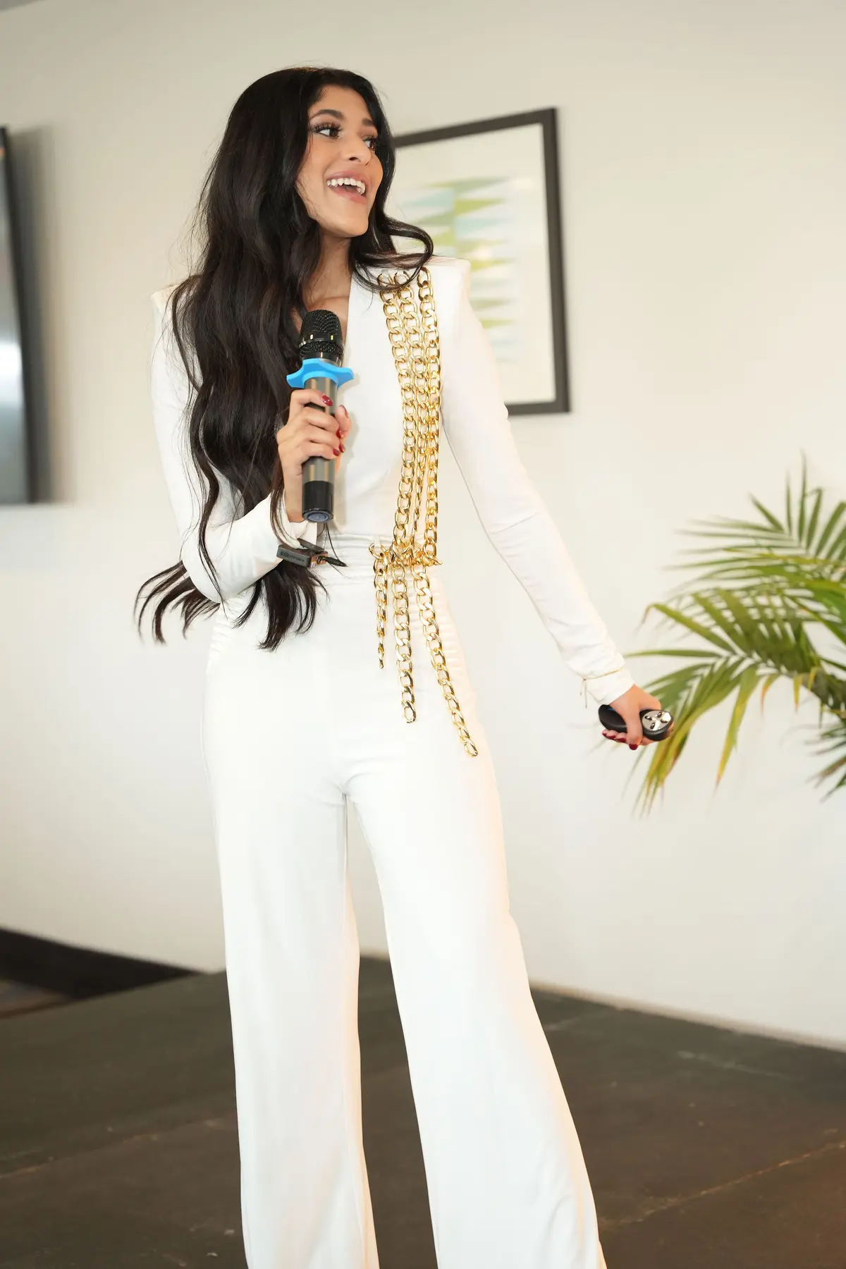 Amber Farooqui on stage holding a microphone