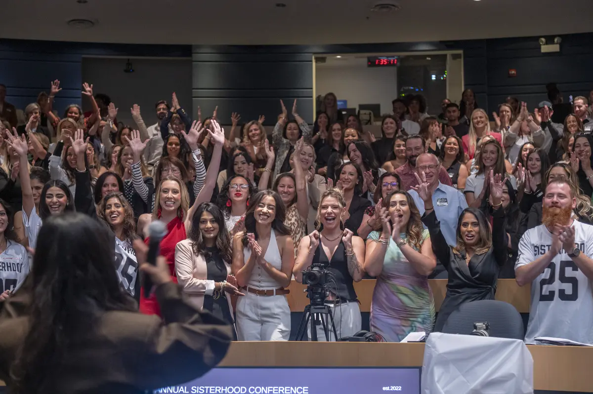 The Sisterhood Conference community cheering together