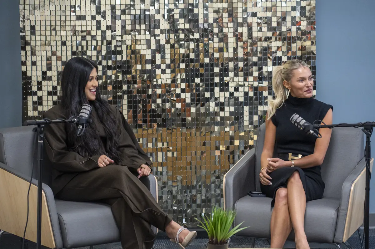 Amber Farooqui and Shelby Sapp seated at podcast microphones