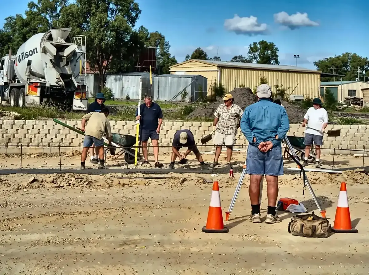 Volunteers laying the slab during early site works on a Goodness Enterprises project