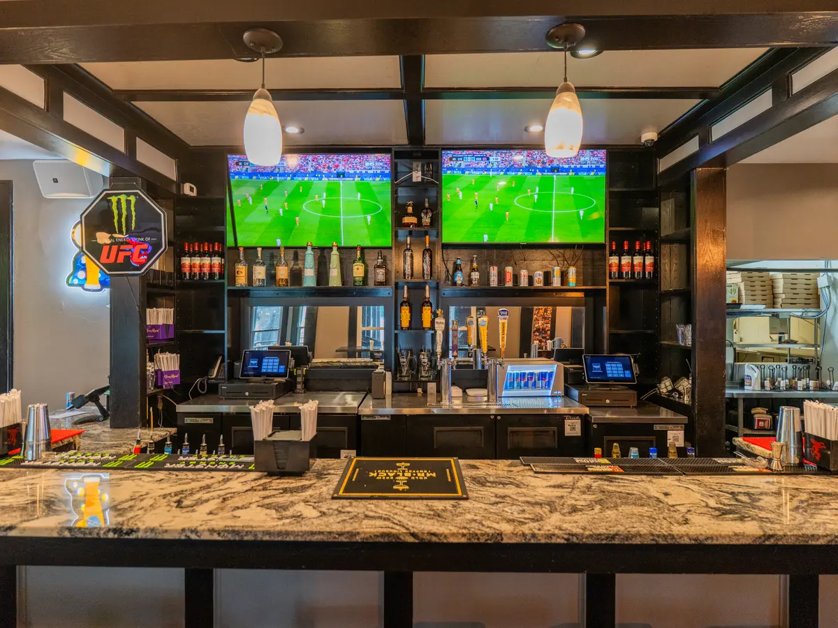The main bar with a wall of TVs showing games