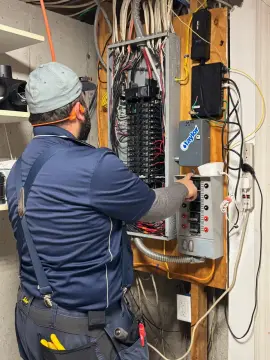 Sylvester Electric technician working at an electrical panel.